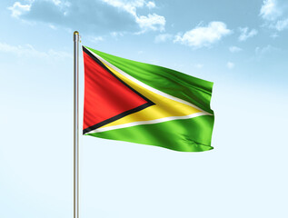 Guyana national flag waving in blue sky with clouds. Guyana flag. 3D illustration