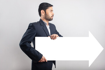 businessman holding a rising arrow sign white empty board in seamless grey background