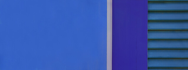 Banner of vintage blue windows with wooden shutters on the exterior of an picturesque house. Colorful facade detail. Space for text.