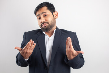 young indian handsome man showing Shrugging shoulders expression, don't know, what