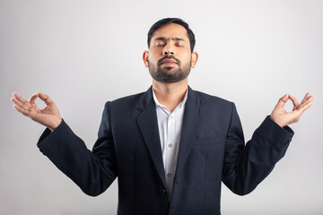 indian businessman with gyan mudra meditation yoga posture in white background