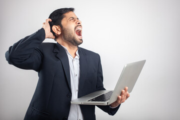 frustrated businessman holding laptop and shouting isolated in white background