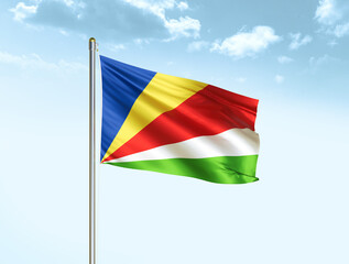Seychelles national flag waving in blue sky with clouds. Seychelles flag. 3D illustration