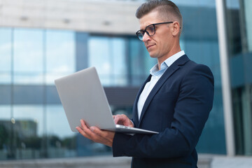 Fototapeta premium Business. Businessman Using Laptop Outdoor Summer Day