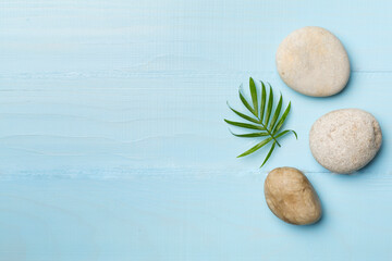 Spa stones and leaves on wooden background, top view © Liami