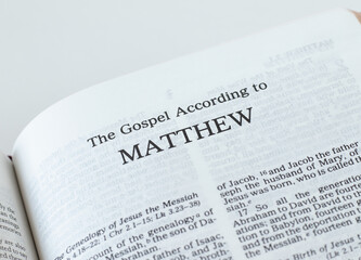 Matthew Gospel from Holy Bible Book inspired by God and Jesus Christ, a closeup. New Testament Scripture isolated on a white background.	