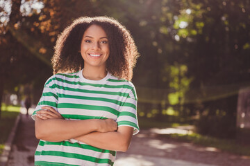 Photo of young charming african lady good mood crossed hands confident forest trees weekend outdoors