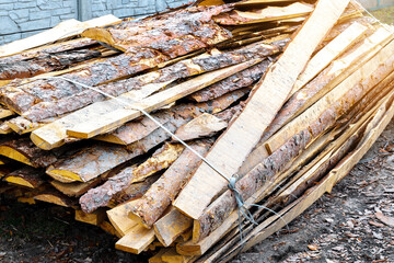Industrial timber wood for carpentry, building or repairing, lumber material for roofing construction. stack natural chopped dry trunks, Fire logs prepared for winter, ready for burning