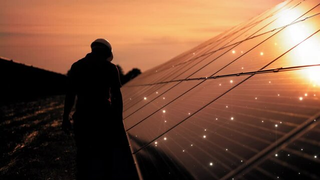 Unidentified solar power engineer touches solar panels with his hand at sunset. Receiving Photons Ecology Renewable Power Station Energy Thin Film Solar Technology Electricity 4K