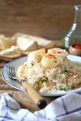 Italian cuisine. Plate of scallop risotto, olive oil and parmesan cheese