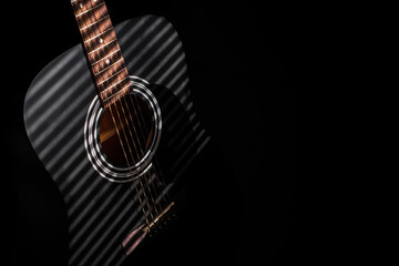 musical instrument black guitar close-up on a dark background
