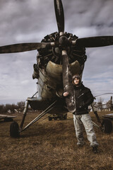 Portrait of young man airplane pilot. Airplane on the background.Old fashion style.