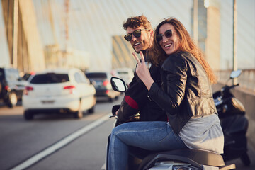 The city is too big to leave unexplored. Rearview shot of a young attractive couple riding a scooter around town.