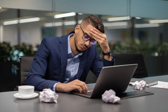 Tired Arab Man Project Manager Sitting In Front Of Computer