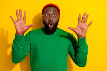 Portrait of attractive crazy scared guy showing stop sign palms isolated over bright yellow color...