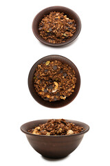 Chocolate granola cereal with nuts in a bowl background.