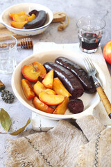 Traditional French cuisine: fried blood sausage and apples