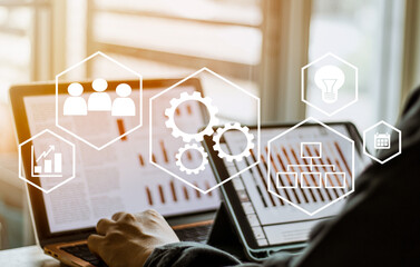 automation and workflow concept, businessman using laptop and digital taplet for working  and process workflow development on virtual screen.