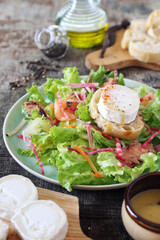 Healthy food. Lettuce salad with red fish, raw carrots, beets and goat cheese