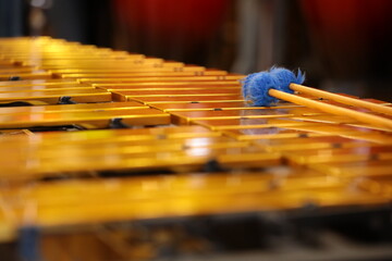 Keys of a golden xylophone with mallets background image of a musical instrument in close-up with...