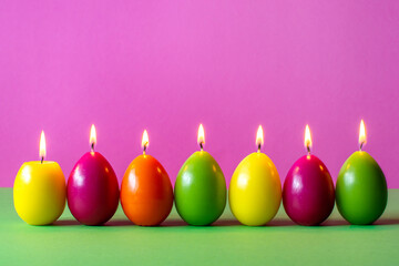 colored candles in the form of painted Easter eggs easter spring holiday