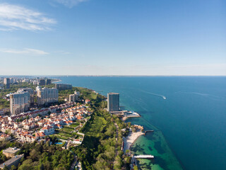 Fototapeta premium Beautiful panoramic aerial view of the sea city Odessa and Arcadia beach on a sunny spring day. Seascape and urban development on the seashore. Travel in Ukraine.