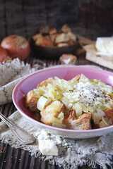 Italian Cuisine. Roman onion soup with toast bread and grated cheese