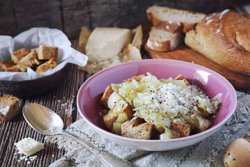 Italian Cuisine. Roman onion soup with toast bread and grated cheese