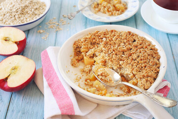 Apple crumble from oatmeal and cup of tea for healthy breakfast - 494304310