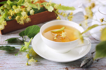 Cup of herbal linden tea with linden flowers