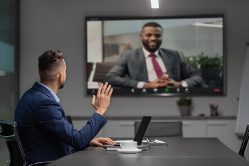 Middle eastern businessman having video conference with african american partner