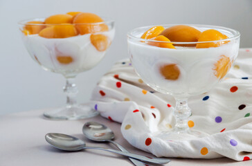 Two bowls of peach slices with yogurt