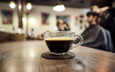 Cup of coffee in barbershop. Client service