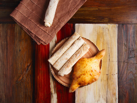 Thin wheat bread, American, Georgian khachapuri. Marku is a flatbread, common in Levant. Yufka is Turkish bread. This is a thin round and unleavened flatbread, similar to pita bread. Wooden background