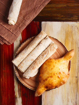 Thin wheat bread, American, Georgian khachapuri. Tortilla for lunch, dinner. Yufka is Turkish bread. This is a thin round and unleavened flatbread, similar to pita bread. Wooden background. Copy space