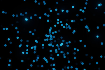 Defocused bokeh lights on black background, an abstract naturally blurred backdrop for Valentines Day or birthday party. Festive light texture. Violet blue garland in blur. Color 2022