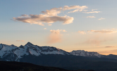 Fototapeta na wymiar Warm snowy mountain landscape in the sunset