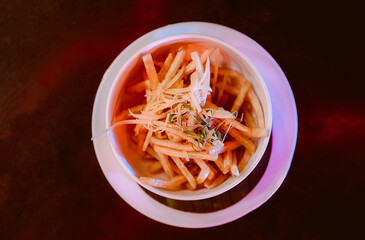 French fries with ketchup on wooden background.