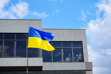 Big national flag of Ukraine on city street
