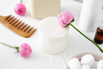 Fototapeta na wymiar Jar of cosmetic product and rose flowers on light background, closeup