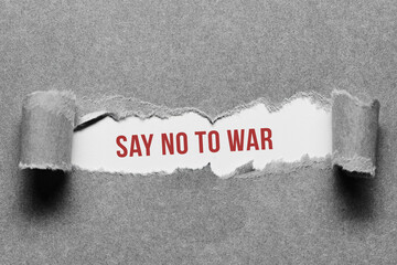torn paper revealing the message SAY NO TO WAR on white background