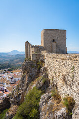 Fototapeta premium View of the medieval castle in the top of the mountain above the beautiful white village of Olvera , Cadiz province, Andalusia, Spain