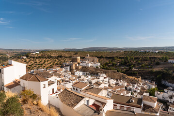 Fototapeta na wymiar Scenic view of the beautiful andalusian white town of Setenil de las Bodegas in the Natural Park of Grazalema mountain range at daylight, Cadiz province, Andalusia, Spain