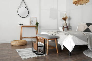 Wooden bench with soft seat in stylish bedroom