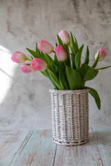 Vase of willow branches with pink tulips