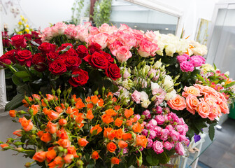 A beautiful bright bouquet of blooming fresh roses for a gift collected by an experienced florist