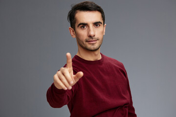man in a sweater posing emotions elegant style Gray background