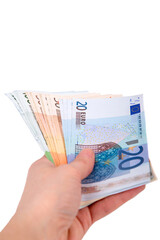 A man holds out a wad of euros in his hand on a white background close-up