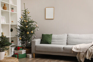 Interior of stylish living room with Christmas tree and sofa