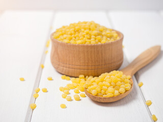 Dry toasted ptitim pasta close-up on a wooden spoon
